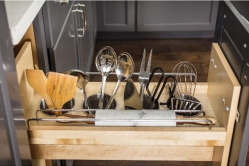 Utension drawer pull-outs allow easy access to spices, oils, and plastic wrap